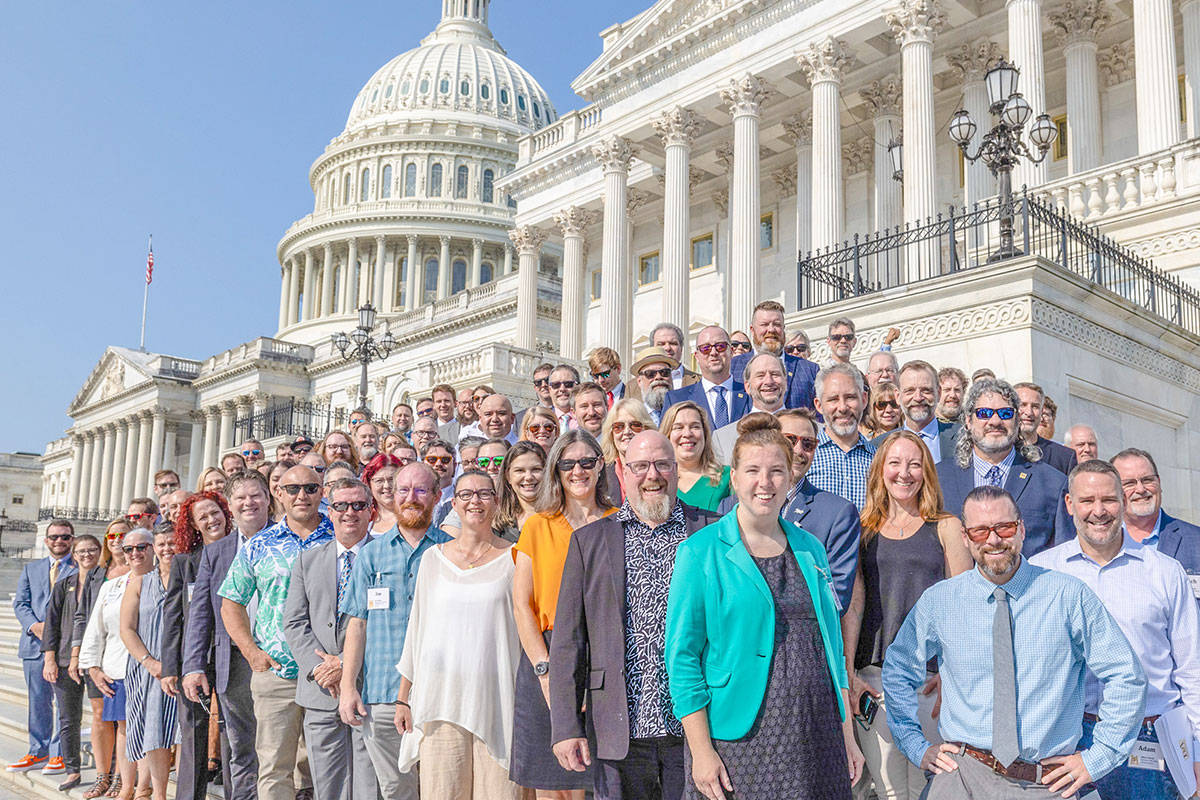 Large group of Brewers Association members standing on the step of capitol hill.